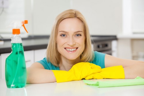 Cleaner wiping shared office surfaces in a Bermondsey workspace